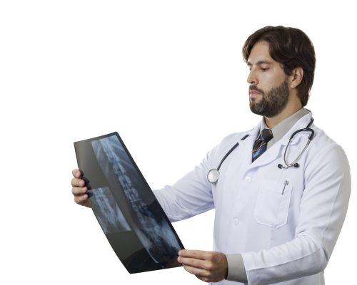 Male doctor looking at a x-Ray on a White background.